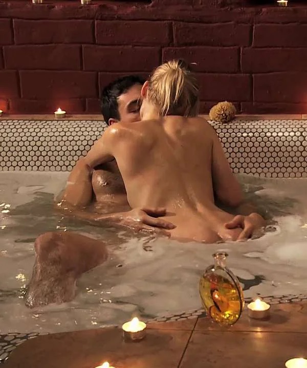 Beautiful blonde makes love in a bathtub with her man with an imposing physique